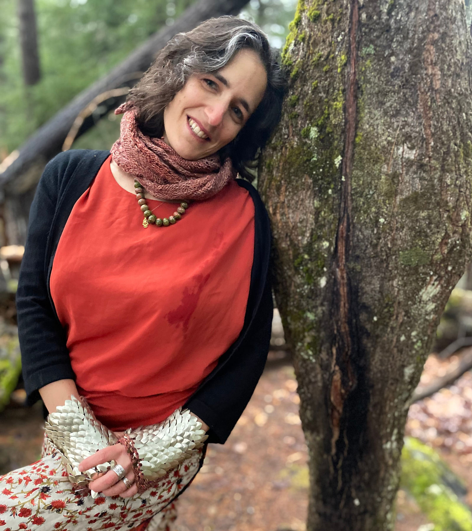 Chaya Aronson RN Chaya Aronson RN outdoors, leading against tree in red shirt